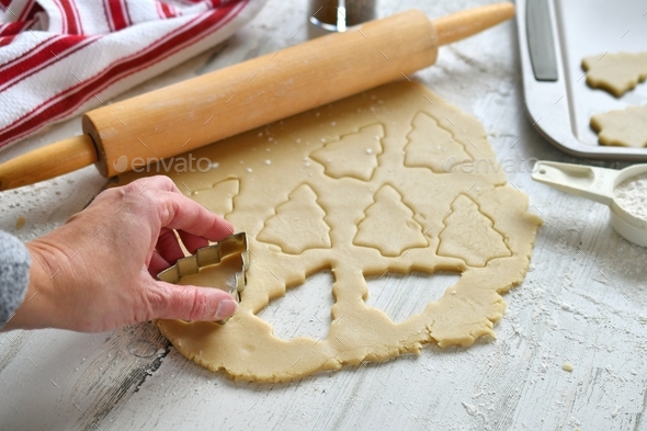 Baking Christmas tree cutout cookies, cookie cutters. rolling pin, dough, bake, kitchen