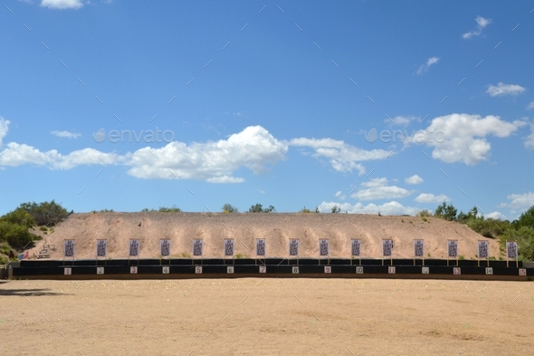 Paper targets at a gun range for target practice firearms training with a gravel berm behind it.