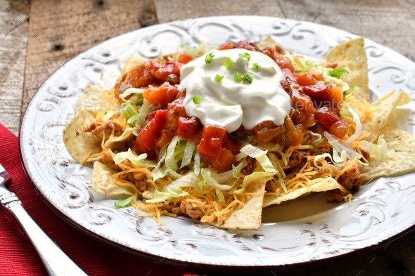Taco Salad Mexican food meal - tortilla chips meat cheese lettuce salsa sour cream