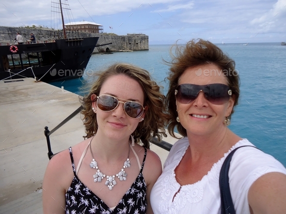 A teenage girl & her middle-aged mom mother getting ready to tour the island of Bermuda, family fun