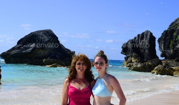 A teenage girl and her middle-aged mom mother enjoying the sunshine and pink sands of Bermuda