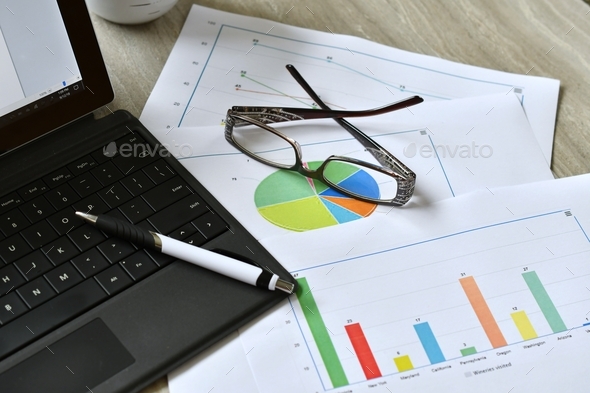Analyzing facts, figures data plot charts for personal or business work. desk, workplace, graphs