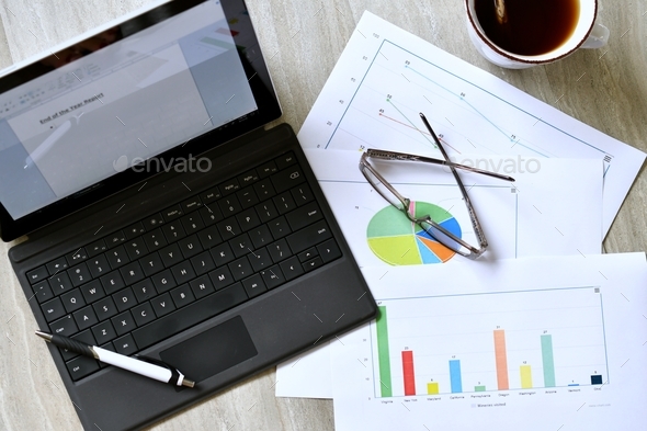 Analyzing facts, figures data plot charts for personal or business work. desk, workplace, graphs