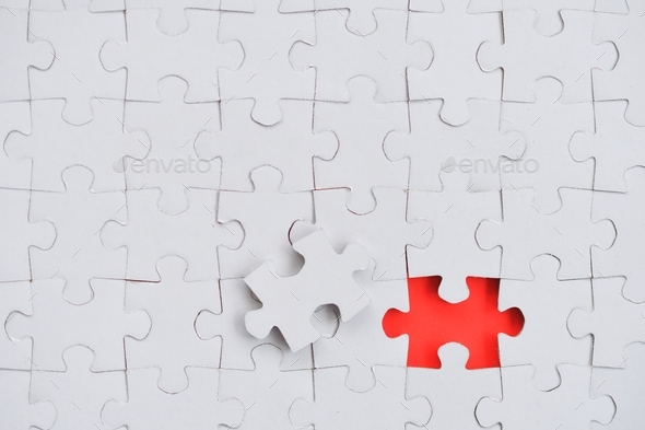 Blank piece for white jigsaw puzzle on red background - add your design or text copy, mock up