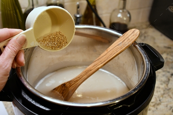 Pouring steel-cut oats into an Instant Pot for creamy tasty porridge.