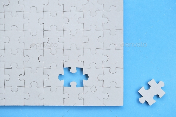 Blank piece for white jigsaw puzzle on blue background - add your design or text copy, mock up