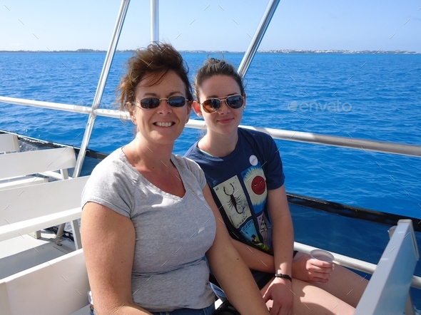 Teenage girl & her middle-aged mom head out on an excursion from their cruise ship to go snorkeling