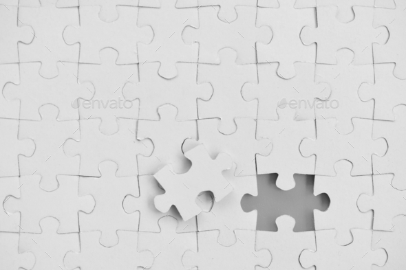 Blank piece for white jigsaw puzzle on gray background - add your design or text copy, mock up