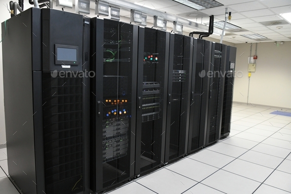 IT Department storage array server racks in a clean bright computer room at a company