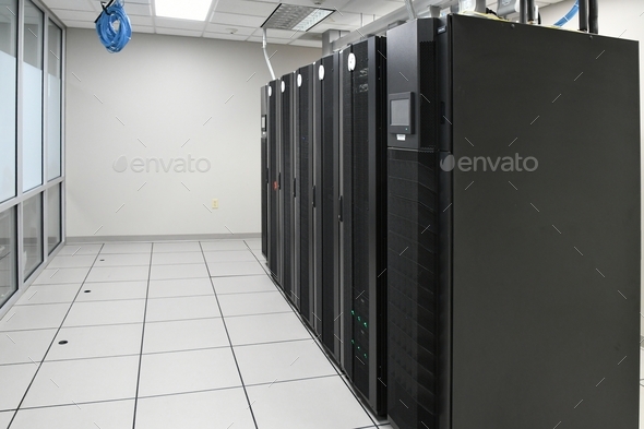 IT Department storage array server racks in a clean bright computer room at a company