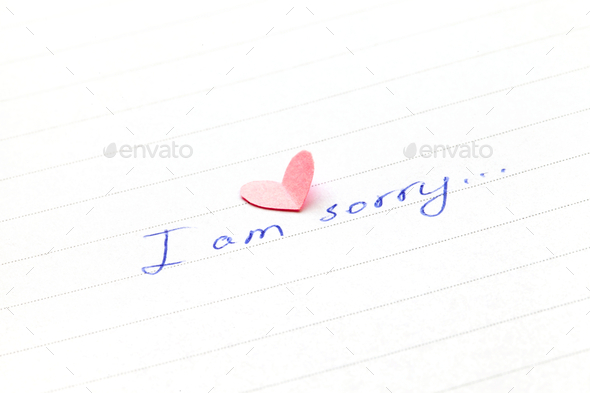 Handwritten words “I am sorry” with a heart