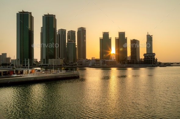 Sunrise in Abu Dhabi. Marina square modern high rise buildings, view from the sea side.