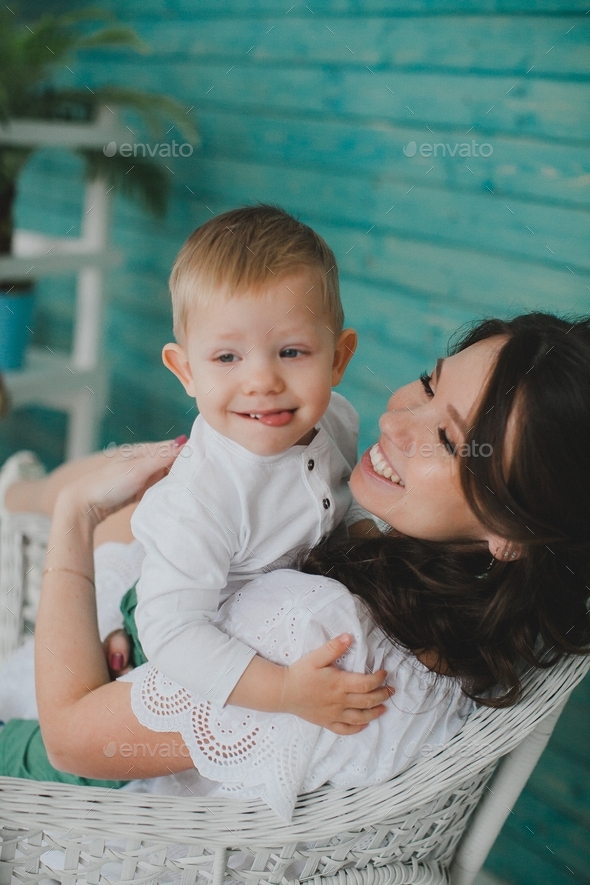 A mother and baby boy is hugging in chair Stock Photo by Katerina_zhiltsova