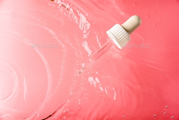 Pipette with transparent liquid in water - Stock Photo - Images