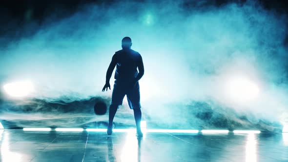 Basketball Practice of a Male Athlete in the Clouds of Smoke alt