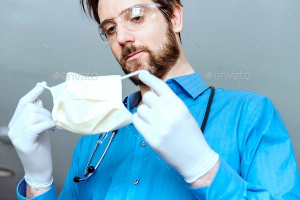 Doctor putting on face mask