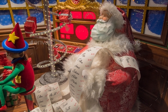 Santa Clause with a list of names, holiday decorations.