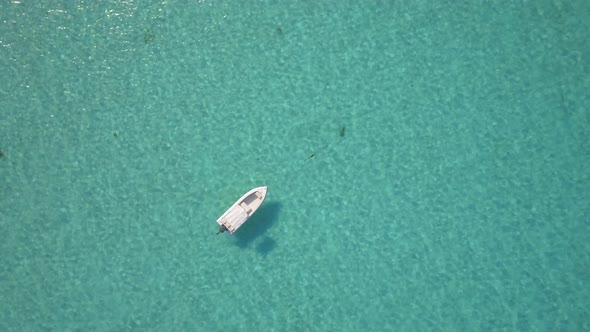 Aerial drone view of a fishing motor boat in the Bahamas, Caribbean.  alt