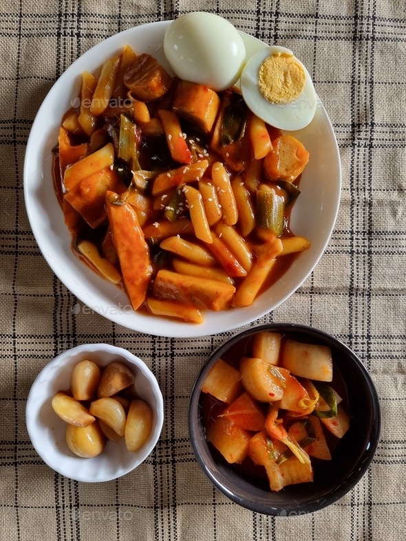 Korean food tteokbokki with radish kimchi and pickled garlic in soy