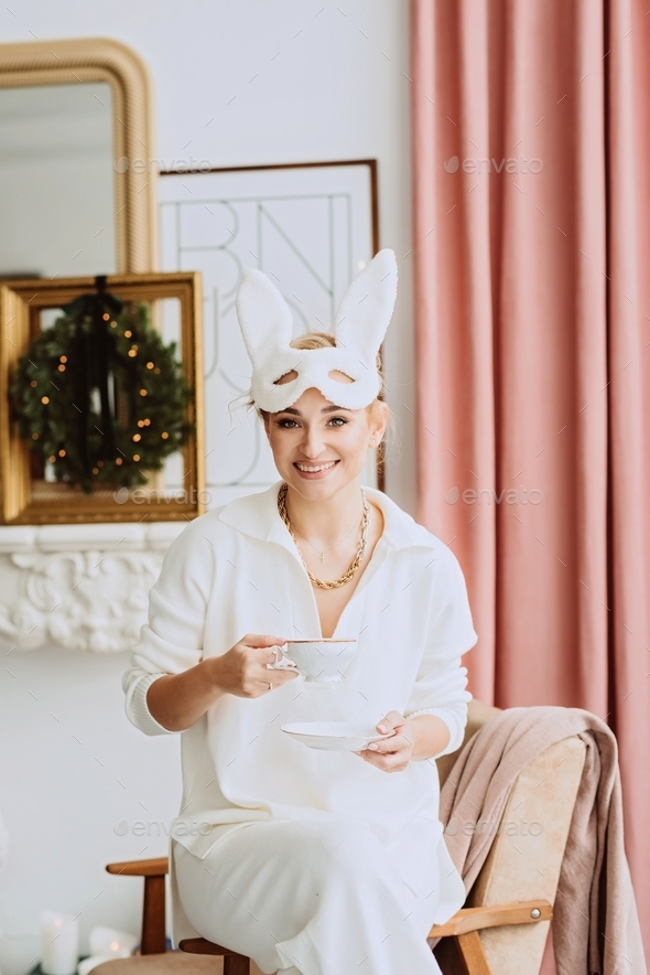 Beautiful young happy woman in carnival rabbit mask and white costume ...