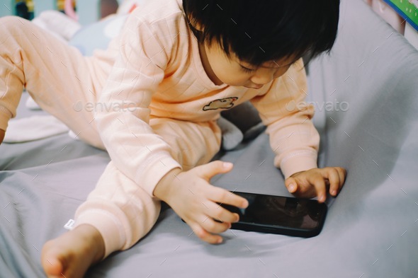Little boy is learning to deal with a phone.