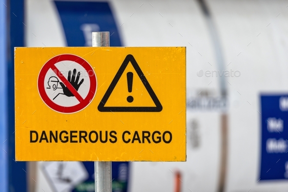 Signs warn of job security. Sign \'dangerous cargo\'.