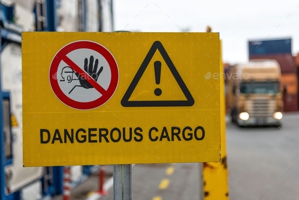 Signs warn of job security. Sign \'dangerous cargo\'.