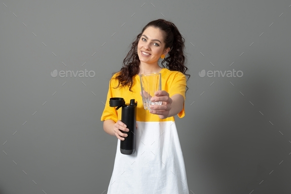 teenager holding eco reusable smart thermo water bottle with drink reminder, health care concept
