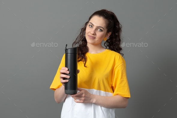 teenager holding eco reusable smart thermo water bottle with drink reminder, health care concept