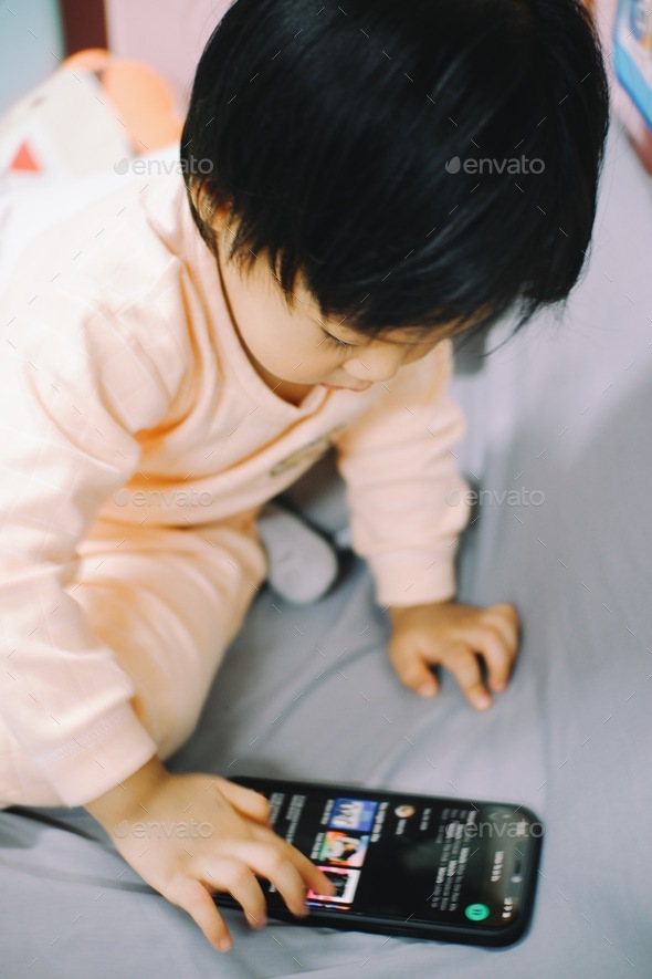 Little boy is learning to deal with a phone.