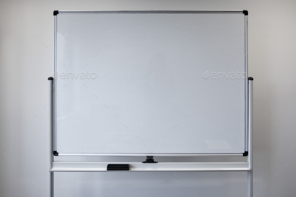 Blank white board against white wall