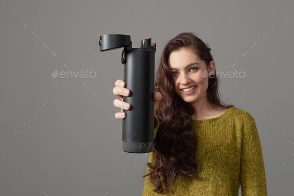 woman holding eco reusable smart thermo water bottle with drink reminder, healthy lifestyle concept
