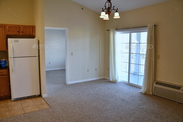 Apartment living room with sliding glass door leading to balcony. Empty no furniture move-in ready