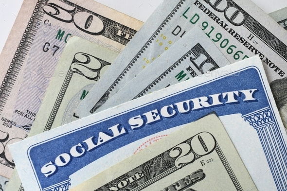 Social Security Card with cash money dollar bills - living on a fixed income, benefits SSN