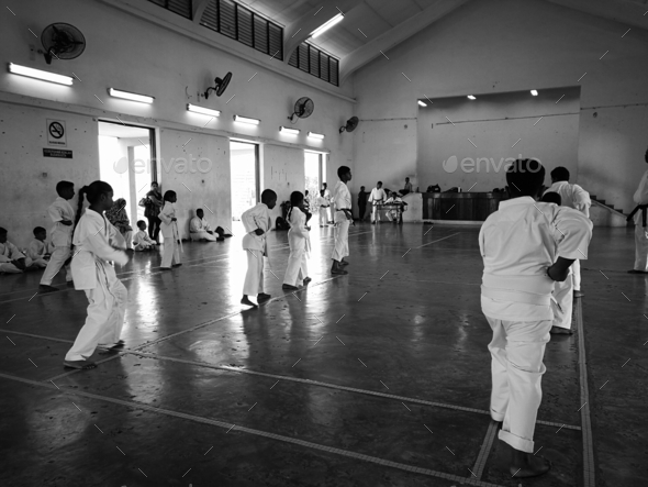 martial art karate do practice in the community hall in malaysia. black and white monochrome