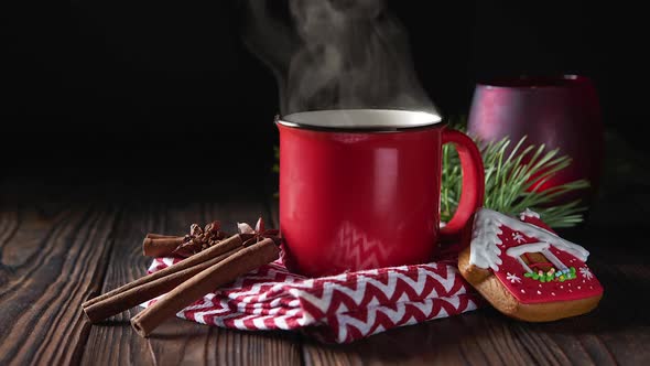 Hot chocolate in red mug with cinnamon and gingerbread