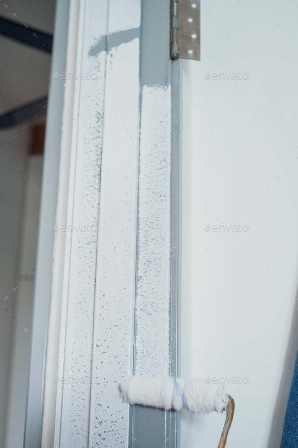 White paint on the door frame. Painting project, DIY at home. Stock