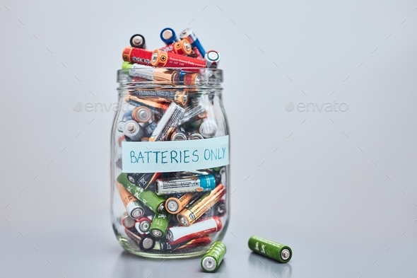 Jar filled with discharged used batteries. Waste disposal and recycling. Separating the waste