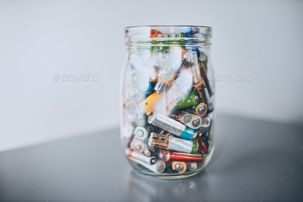 Jar filled with discharged used batteries. Waste disposal and recycling. Separating the waste