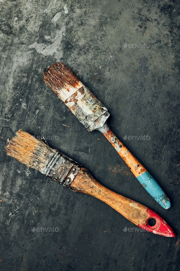 Paintbrushes on metal surface. Old brush set for house maintenance. Technical background