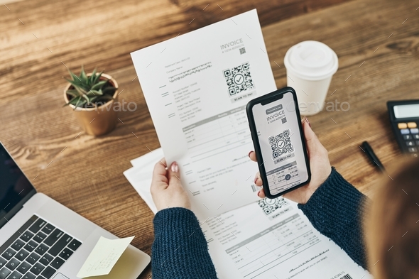 Scanning QR code from invoice to make payment using fast payment system and smartphone code reader