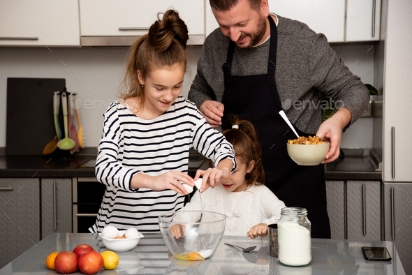 Dad and daughters make apple pie. House. Cooking. Comfort. Stock Photo ...