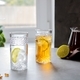Two glasses, one with ice, the second with iced tea  with a slices of lime. Close-up. - PhotoDune Item for Sale