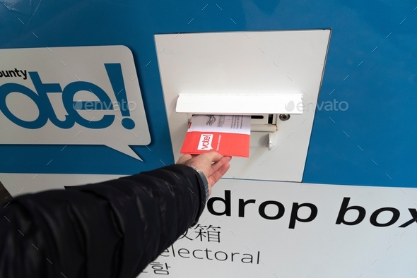 Point of view putting election ballot envelope into a drop box. - Stock Photo - Images