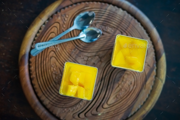 Mango Panna cotta with mango jelly, Italian dessert, homemade cuisine in a container.
