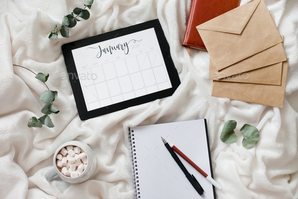 Calendar flat lay month january, writing to-do list for a new month and planning for new year