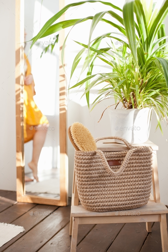 Jute bag and body brush in the bali style bathroom, green plant