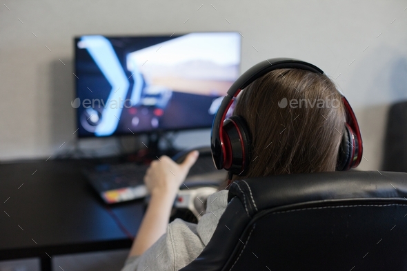 young woman playing a video game, driving, people using technology people playing computer games