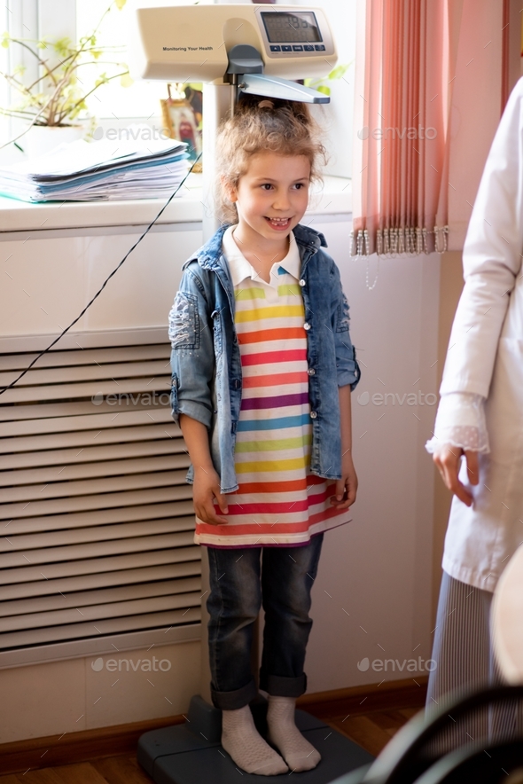 A little girl at a doctor\'s appointment.