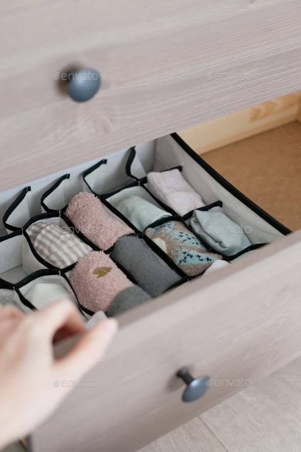 Organizing socks drawer and a gand opening the drawer (chest of drawers, folding socks